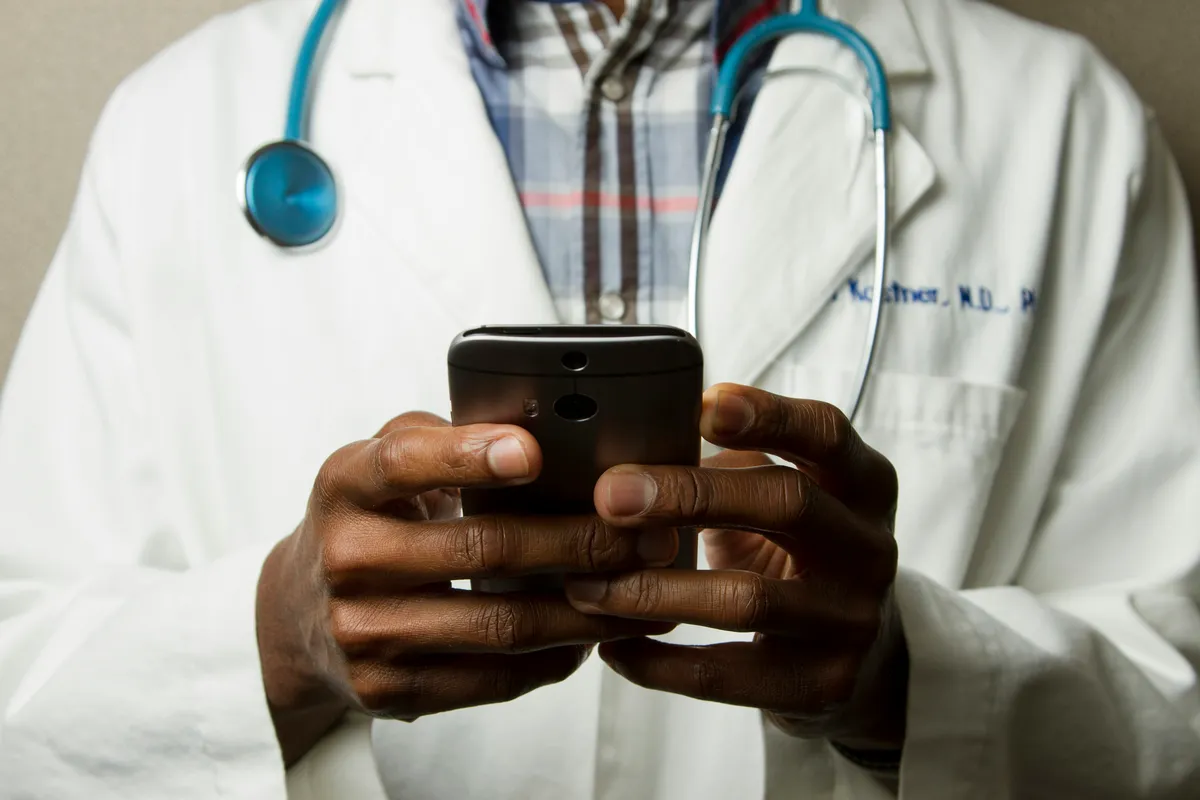 Healthcare provider consulting with family in medical office